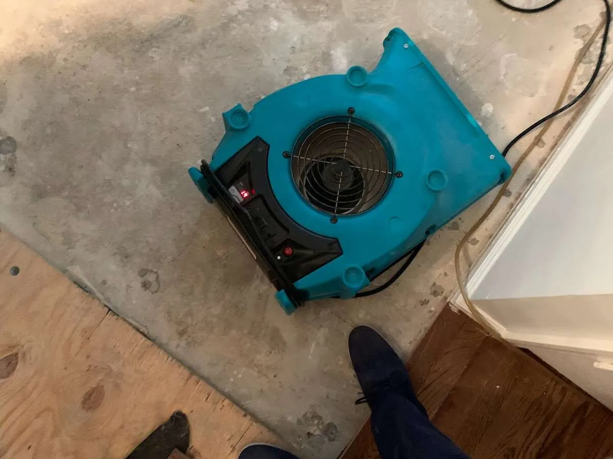 Air mover drying subfloor during Leak Detection & Repair in East Point